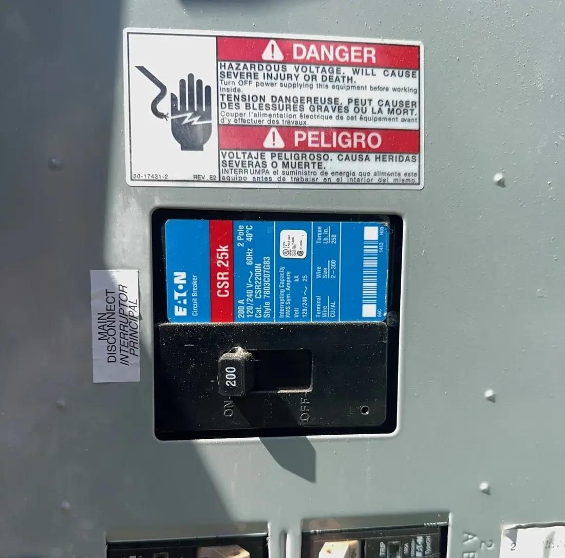Close view of a 200 amp Eaton main circuit breaker labelled Main Disconnect