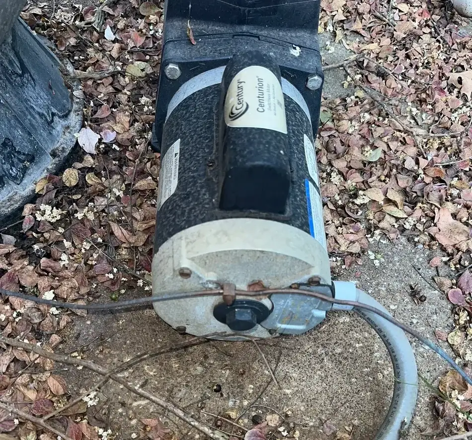 Close view of a pool pump motor showing significant corrosion on the housing and end bell