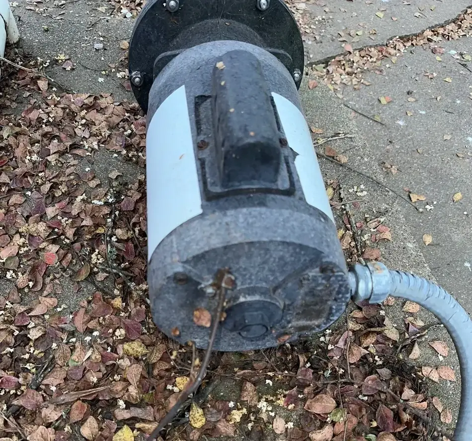 A pool pump motor from the opposite side showing heavy corrosion and pitting