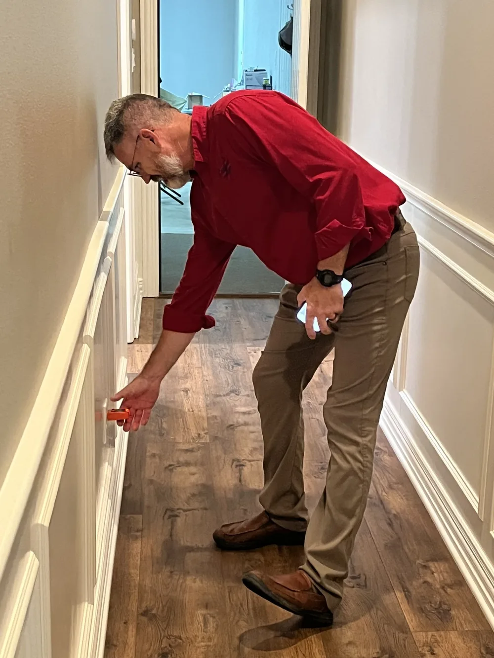 Jeff Stalnaker testing an electrical outlet with a receptacle tester during a home inspection
